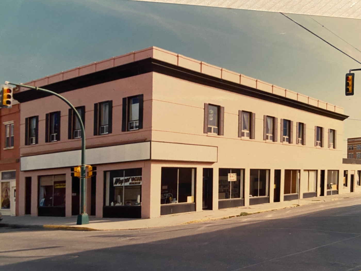 The building freshly painted with dark trim and shutters