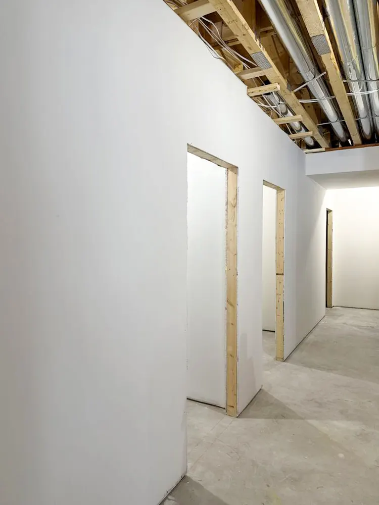 Hallway with freshly taped and mudded drywall