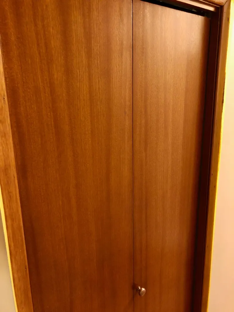 Wood door and frame with a rich, even reddish-brown stain and the grain showing through