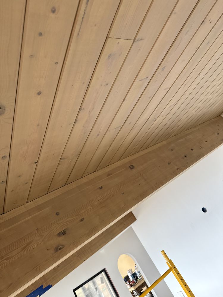 Freshly stained pine plank ceiling and beam